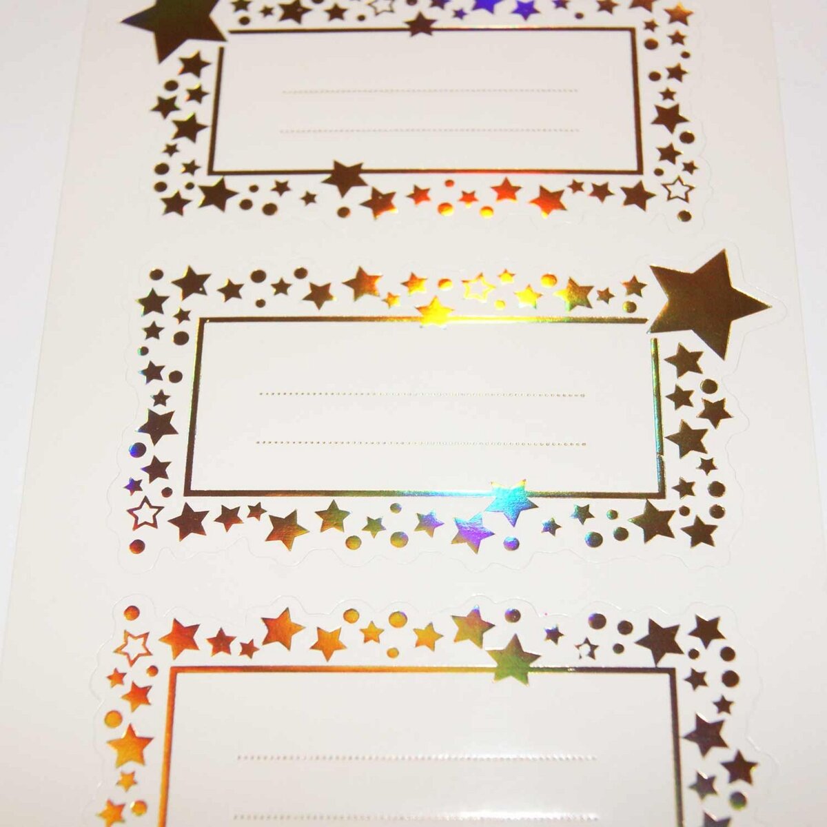  12 étiquettes adhésives de Noël - Étoiles dorées iridescentes